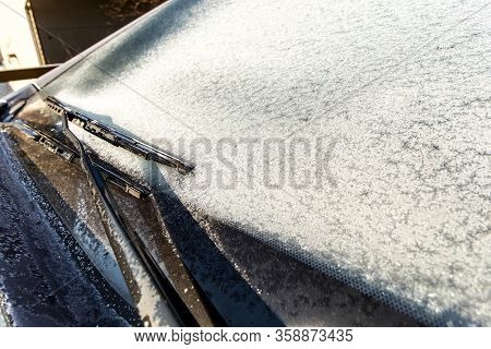 Frozen Car Windshield Covered With Ice And Snow On A Spring Day. Frosty Morning. Spring Frost On The