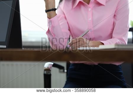 Woman Sitting Office Takes Notes During Discussion. Well-equipped Workplace. Attendant Support Staff