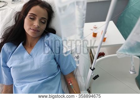 Beautiful Girl Sleeps In Clinic Under Drug Dropper. Qualified Help. Ensuring Implementation Complex 