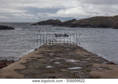 Ofoten, Norway - June 20, 2017: Fishing Boat In The Water Of The Norwegian Fjords In Cloudy Day.