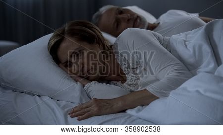 Aging Couple Lying Sleepless In Bed, Woman Turned Back To Man, Resentment
