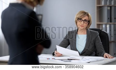 Strict Serious Lady Boss Looking Contemptuously At Secretary, Poor Performance