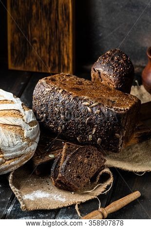 Assortment Of Baked Goods On Wood Background. Rye Bread. Wheat Bread. Vegeterain Food Concept. Sourd