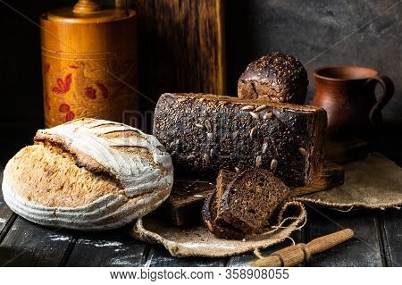Assortment Of Baked Goods On Wood Background. Rye Bread. Wheat Bread. Vegeterain Food Concept. Sourd