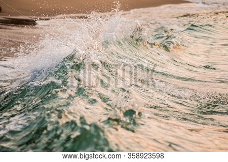 Colorgraded Waves Splashing On The Shore During Sunset