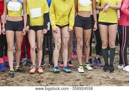 Young Female Atheletes Ready To Run. Race Start Line. Athleticism