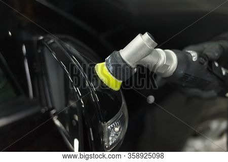 Process Of Polishing Car Mirrors With A Polishing Machine And Wax. Removing Scratches From A Car Bod