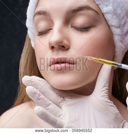Young Pretty Woman Studio Portrait. Cosmetology Biorevitalization Concept. Esthetic Woman Injection 
