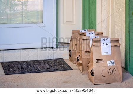 Fort Collins, CO, USA - March 31, 2020: Brown bags with groceries delivered to house from Whole Food Market and order through Amazon Prime. Online shopping during coronavirus pandemic.