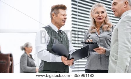 Close Up. Group Of Employees Discussing Documents Standing In The Office