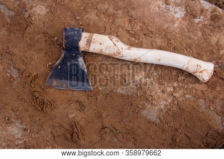 Ax On The Background Of Building Mud. Hand Ax.