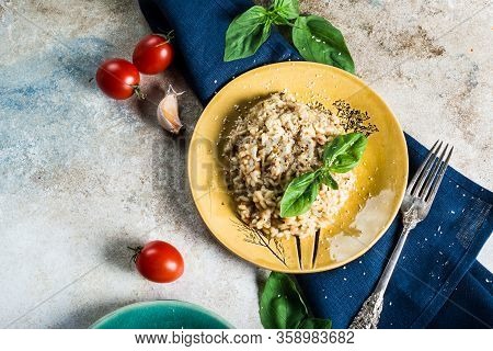 Risotto With Tomatoes On A Green Plate With Basil. Italian Food. Vegan Food Concept. Italian Cuisine