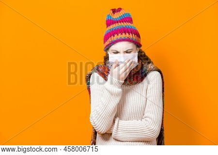 Healthcare Ideas.teenage Female Girl In Warm Knitted Hat And Scarf Using Facial Mask Against Viruses
