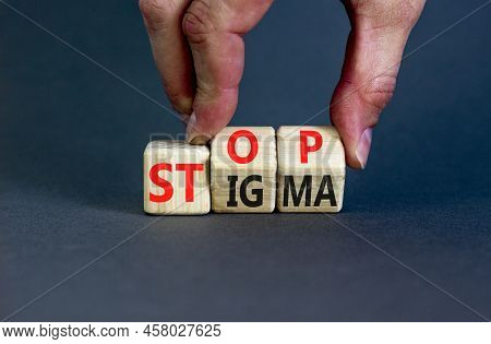 Stop Stigma Symbol. Concept Words Stop Stigma On Wooden Cubes. Businessman Hand. Beautiful Grey Tabl