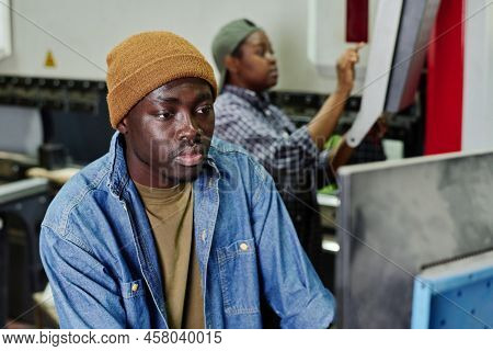 African Operator Choosing Program On Computer Machine While Working At Plant