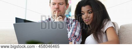 Portrait Of Middle Aged Man And Latino American Woman Watch Impressive Film Online. Couple Think On 