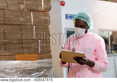 American Raw Material Inspector Work With Computer To Take Note Inspect Data For Use In The Factory.