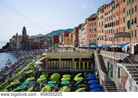 Camogli, Liguria, Italy - June, 2022:  Beach With Many Green Umbrellas And Chaise Lounges On Mediter