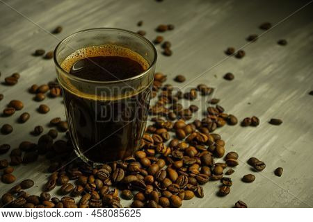 Black roasted coffee beans. Cezva cup coffee glass rustic style Turkish ground coffee