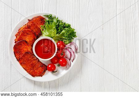 Grilled Slices Of Pork Loin Marinated In Paprika Based Sauce With Tomatoes And Lettuce, Red Onion On