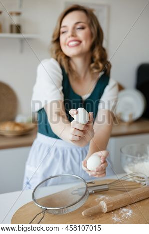 Girl Confectioner Holding Chicken Eggs In Her Hands