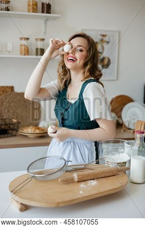 Girl Confectioner Holding Chicken Eggs In Her Hands