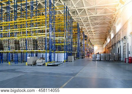 Interior Of A Modern Warehouse Storage Of Retail Shop With Pallet Truck Near Shelves