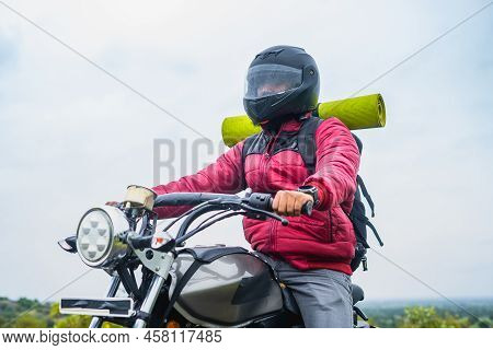 Rider With Backback On Bike Traveling With Helmet - Concept Of Explorer, Vacations And Holidays