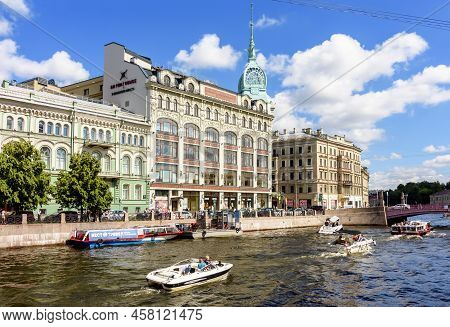 Saint Petersburg, Russia - July 2022: House At Red Bridge And Boats Along Moyka River