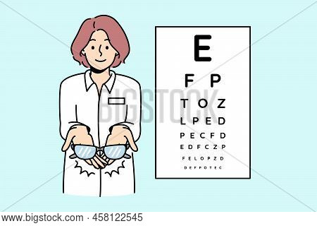 Female Ophthalmologist Holding Glasses On Background Eye Check Chart. Eyesight Checkup In Ophthalmol