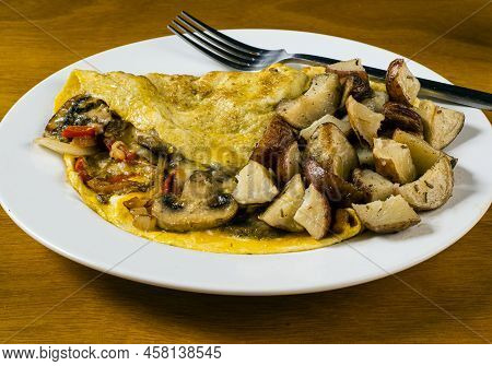 Mushroon Peppers And Onion Omelet Served With Home Fries