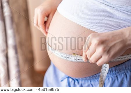 Pregnant Belly Woman Measure. Happy Beautiful Pregnant Woman With Tape Measuring Belly. Pregnancy, M