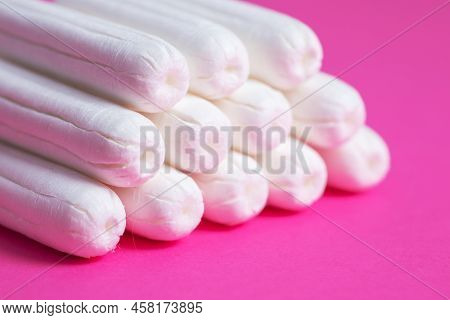 Medical Female Tampon Close Up On A Pink Background. Hygienic White Tampon For Women. Cotton Swab. M