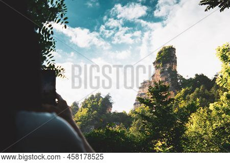 Female Person Take Photo Of Sairme Pillars In Summer With Sky Background. Hidden Gem In Georgia