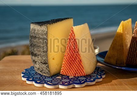 Assortment Of Spanish Hard Cheeses, Curado, Manchego, Goat Cheese Served Outdoor With Membrillo Jam