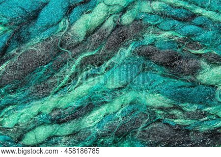 Close-up Of Colourful Merino Wool Emerald And Grey Striped Background. Abstract Handmade Craft Knitt