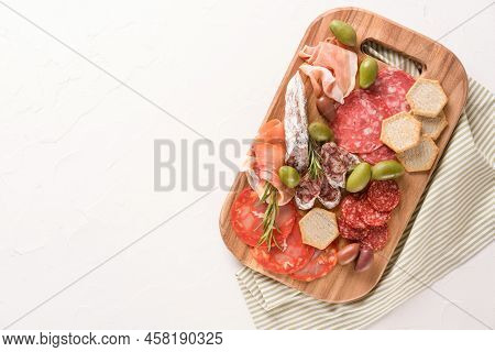 Charcuterie Board With Variery Of Sausages - Salami, Bresaola, Proscuitto Served With Olives And Cra