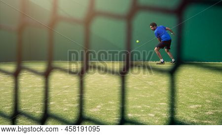 Professional Monitor Of Padel Jump To The Ball With A Black Racket. Class To Student On Outdoor Tenn