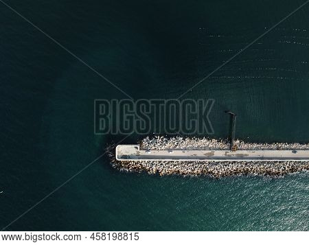 Aerial Drone View Of A Breakwater. Tetrapod Pier Along The Shore, Sea Waves Breaking On Tetrapod Pie