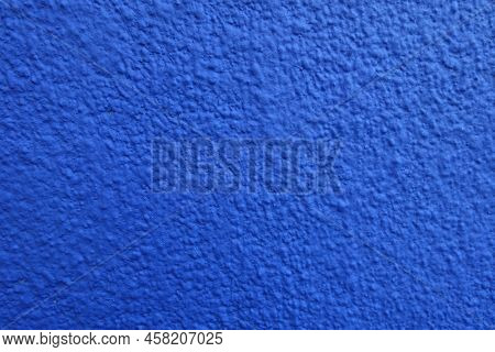 Close Shot Of Wall With Coarse Vibrant Blue Roughcast Finish