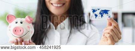 Portrait Of Woman Hold Piggybank Money Container In One Hand And Credit Card In Another. Best Option