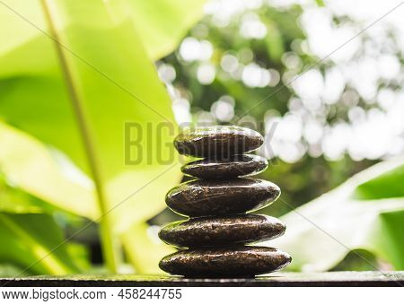 Stack Pyramid Stone Zen Pebbles Nature On Wooden With Blur Green Nater Outdoor. Meditation Tranquil 