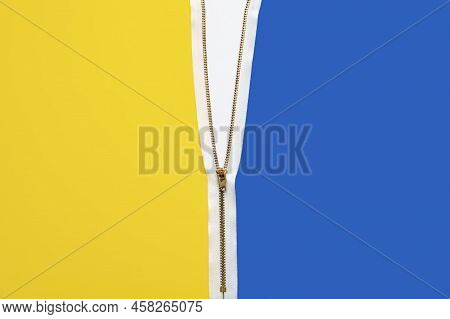 Gold Metal And White Half-open Zipper Dividing In The Middle Yellow And Blue Colors. Top View With C