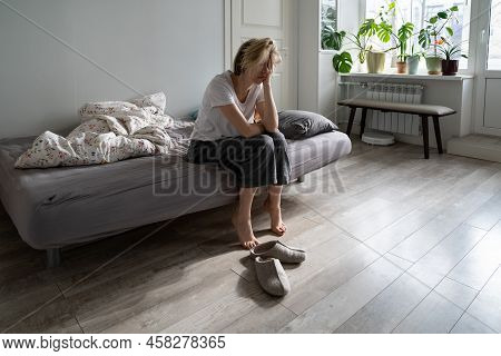Upset Depressed Woman Holding Head In Hands Sitting On Bed At Home, Unhappy Frustrated Single Female