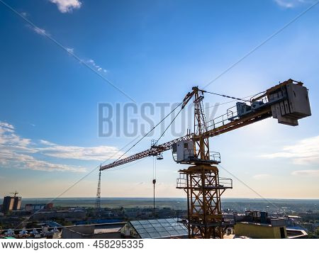 Construction Crane On The Background Of A Clear Day Sky Aerial View. Flyby Of A Construction Crane O