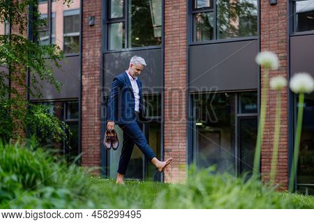 Businessman Walking Barefoot In Park, Feeling Free, Work Life Balance Concept.
