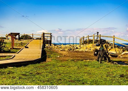 Asturias Coast At Cape Penas In North Spain. Walking Area On Top Of Cliffs. Bicycle And Professional