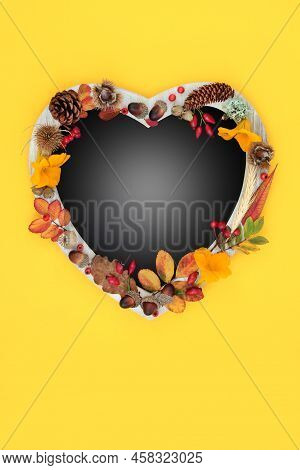 Heart Shaped Autumn Harvest Festival  Frame, Leaves, Flowers, Berries, Grain And Nuts. Thanskgiving 