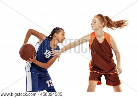 Studio Shot Of Beginner Basketball Players, Young Girls, Teen Training With Basketball Ball Isolated