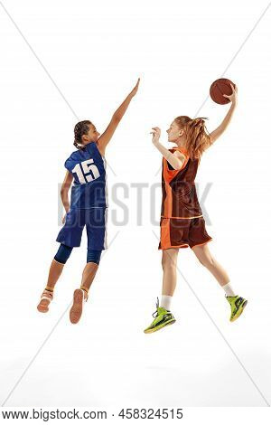 Studio Shot Of Beginner Basketball Players, Young Girls, Teen Training With Basketball Ball Isolated